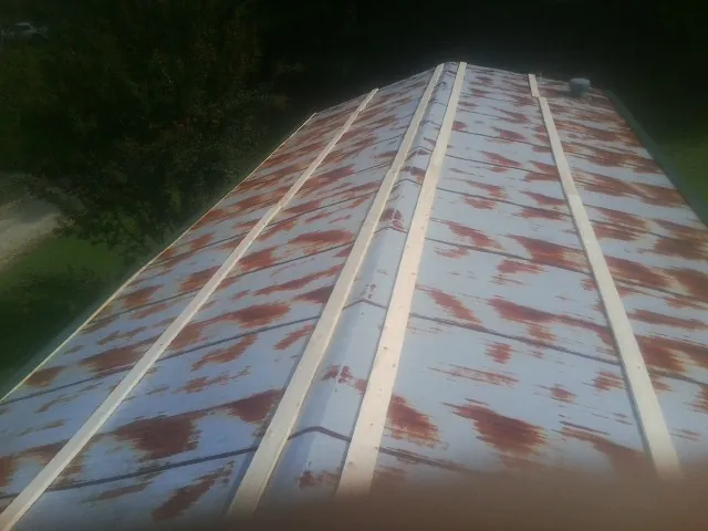 Rusted metal roof panels with new wood purlins before replacement — Storm Damage Roof Repair in Gamaliel by Roofing Brothers