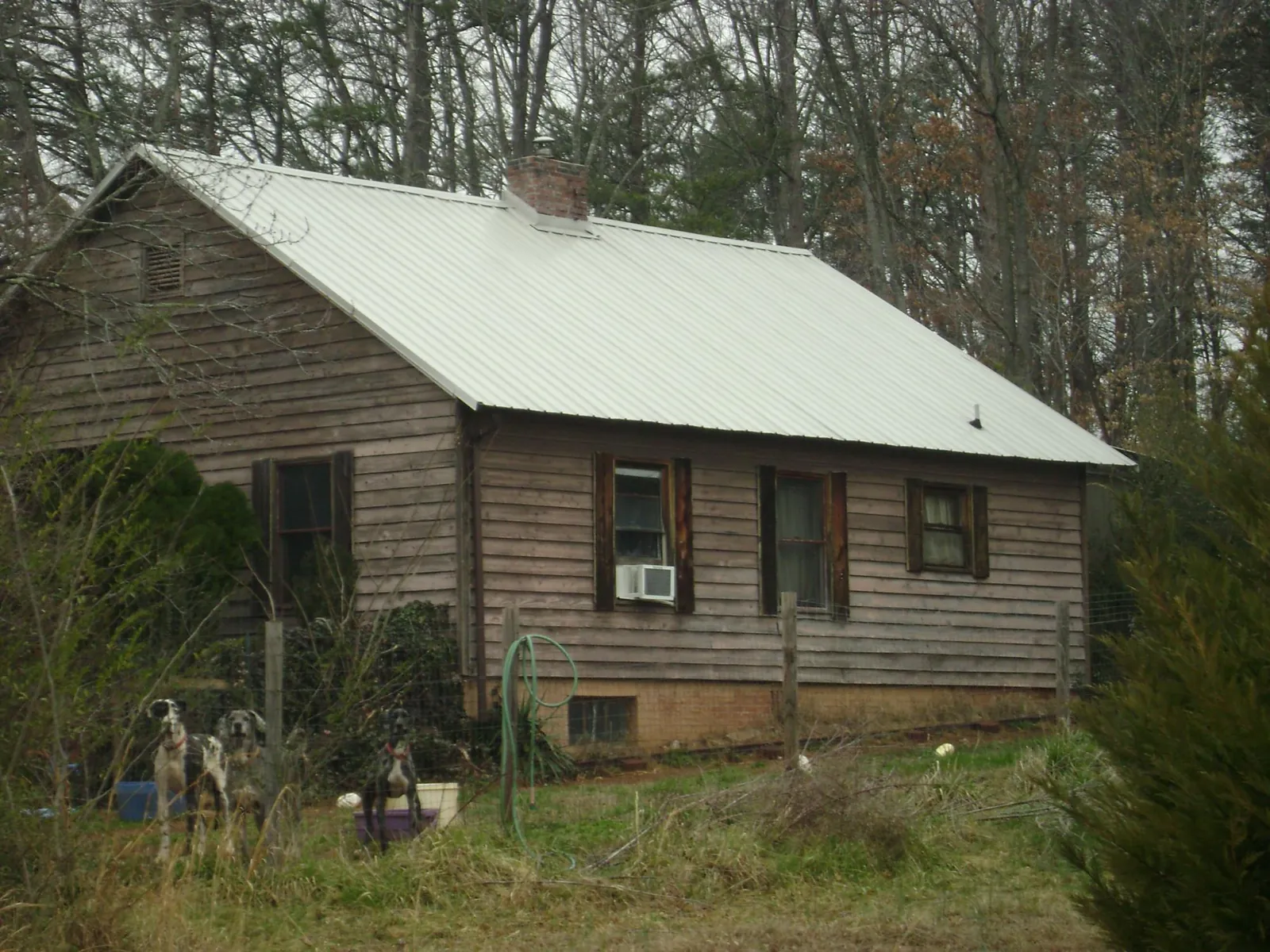 White metal roof on an old wood sided farmhouse, from a Metal Roof Installation job in Gamaliel